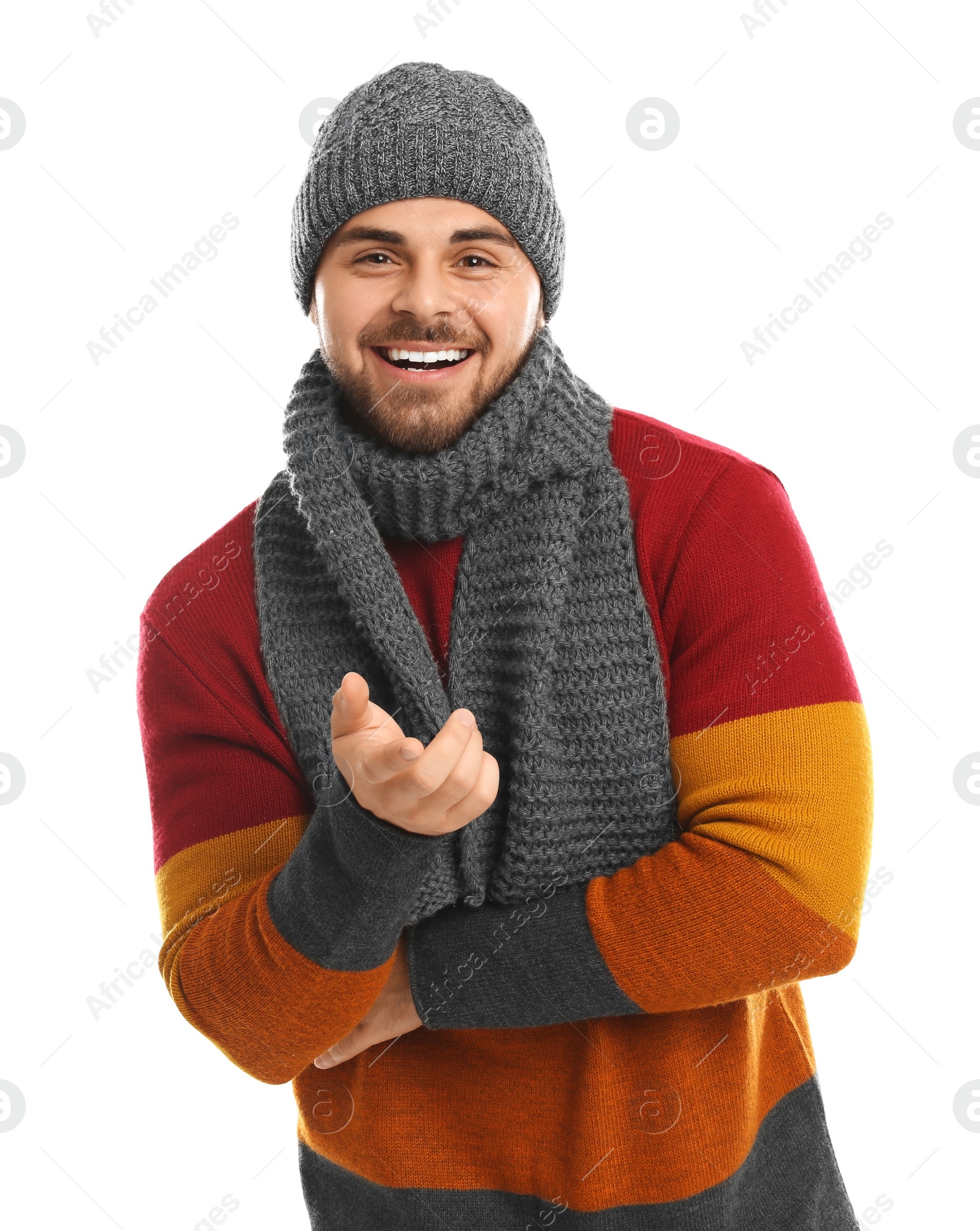 Photo of Emotional young man in warm clothes on white background. Winter vacation