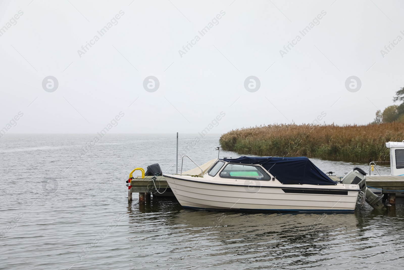 Photo of Picturesque view of pier with moored boat