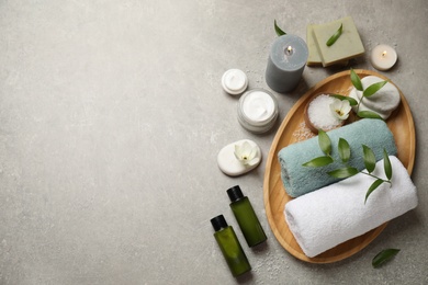 Photo of Flat lay spa composition with skin care products on grey textured table, space for text