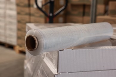 Photo of Roll of stretch wrap on box in warehouse