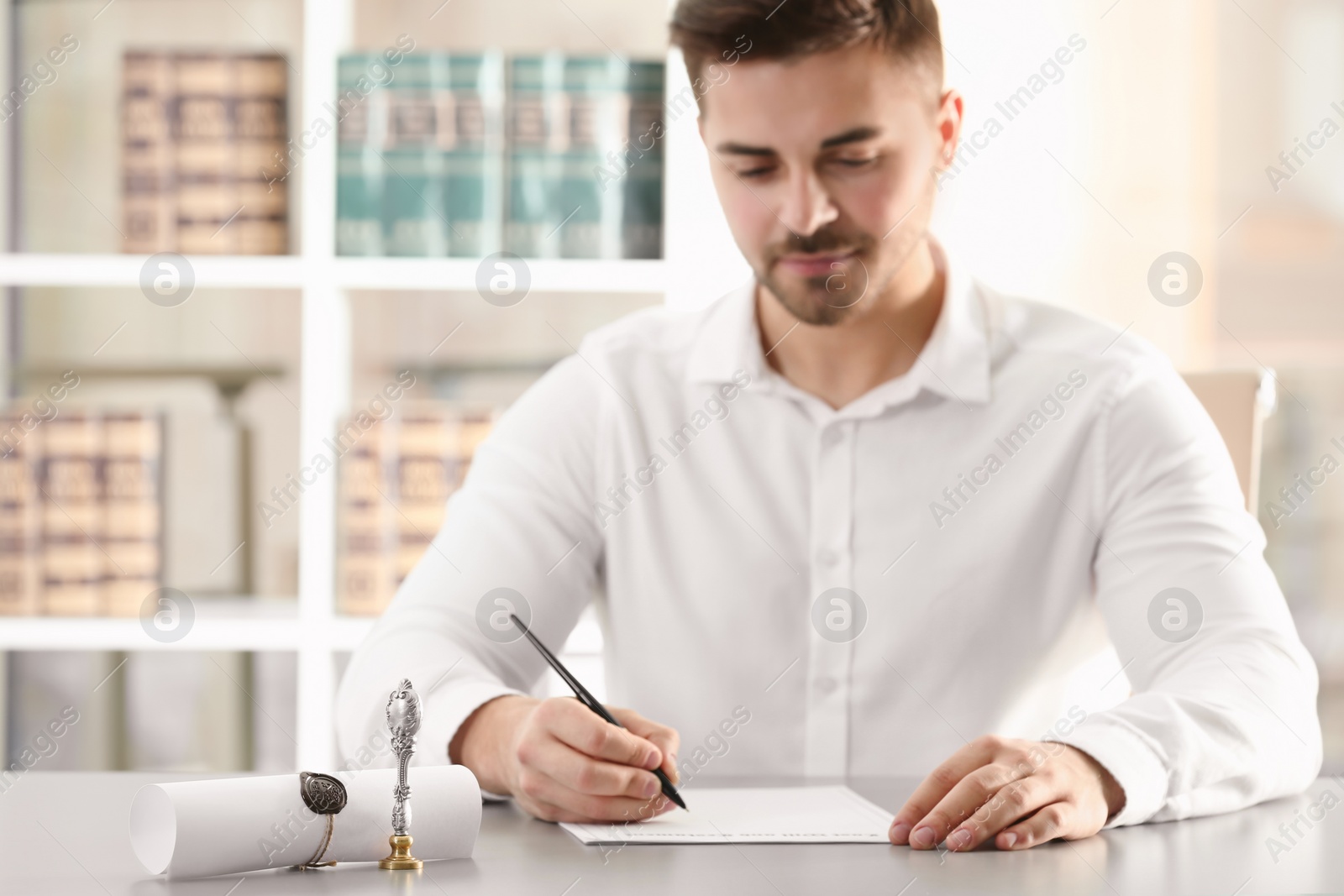 Photo of Male notary working with documents at table