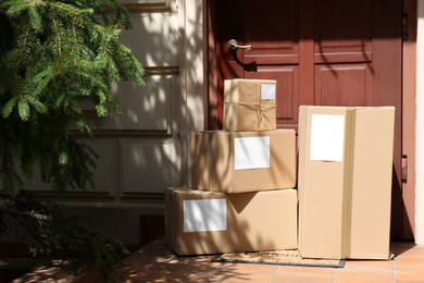 Photo of Delivered parcels on door mat near entrance