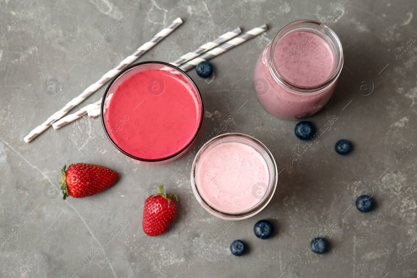 Photo of Flat lay composition with healthy detox smoothies and ingredients on grey background