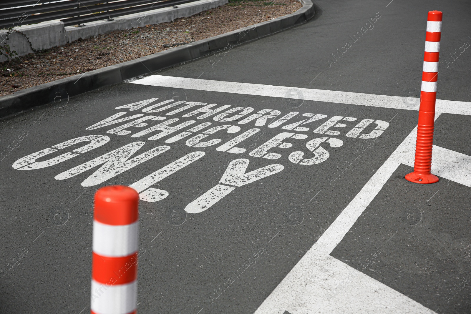 Image of Sign Authorized Vehicles Only painted on asphalt outdoors