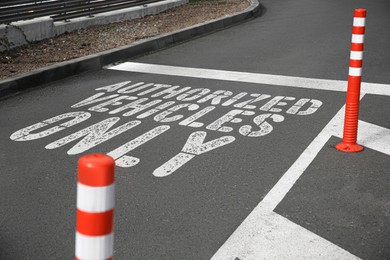 Image of Sign Authorized Vehicles Only painted on asphalt outdoors