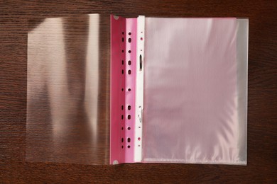 File folder with punched pockets on wooden table, top view
