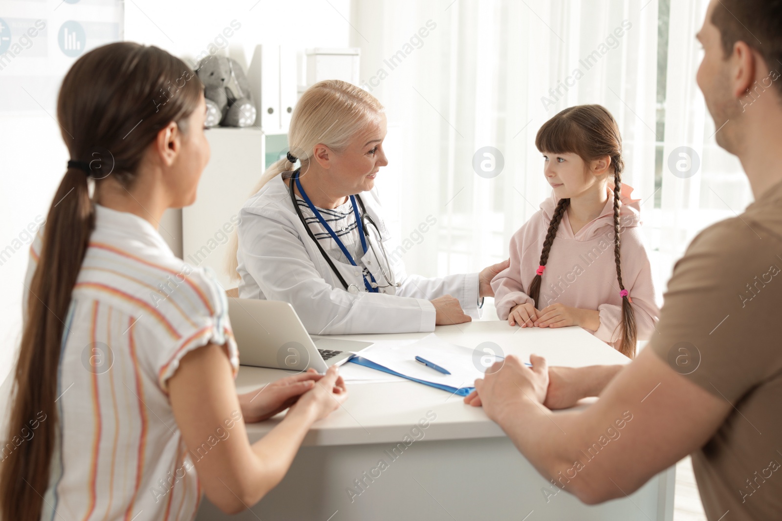 Photo of Family with child visiting doctor in hospital