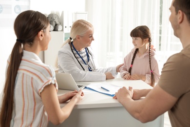 Family with child visiting doctor in hospital