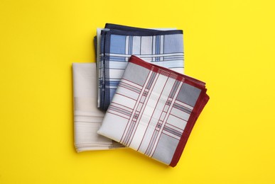Photo of Stylish handkerchiefs on yellow background, flat lay