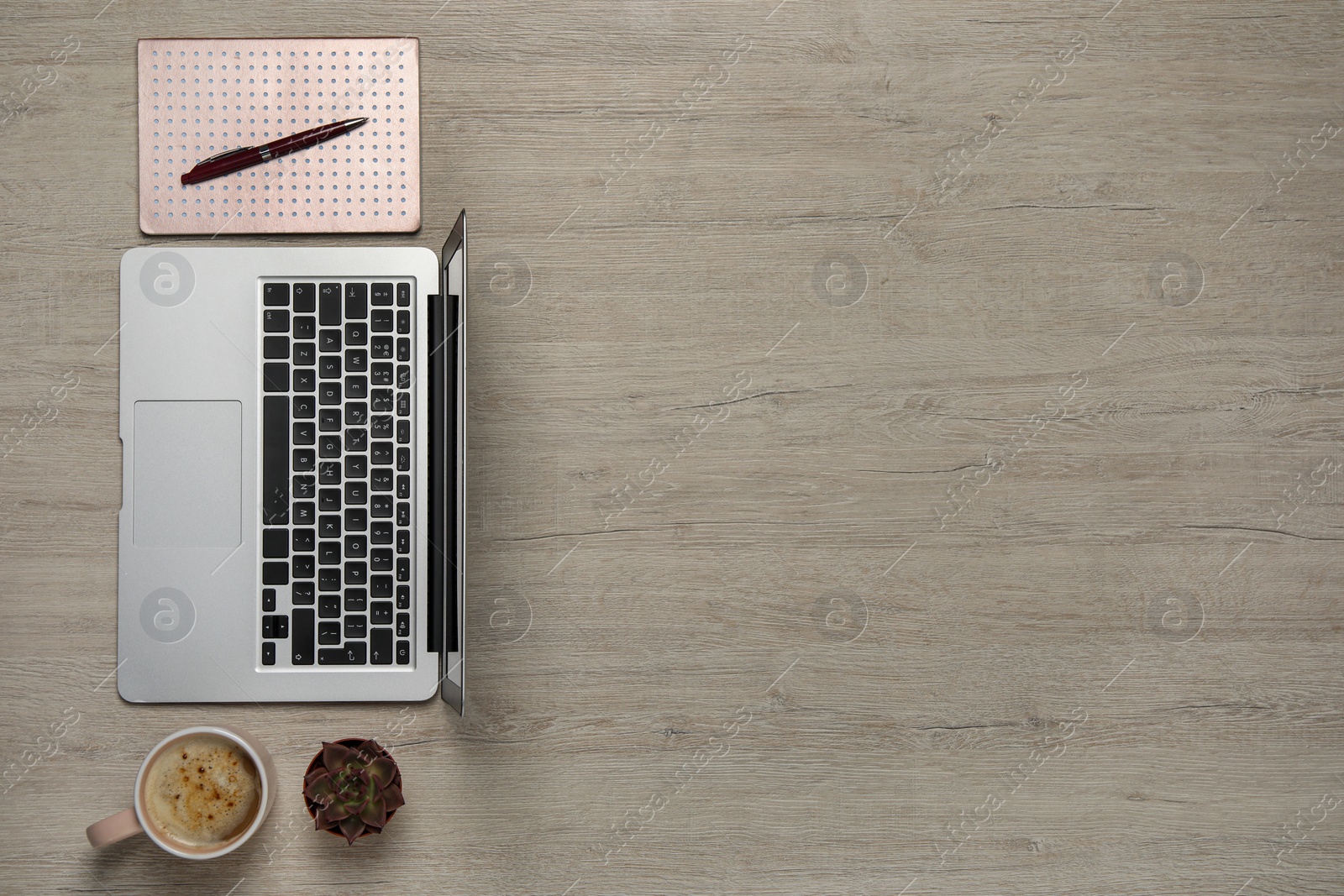 Photo of Modern laptop, houseplant, notebook and cup of coffee on wooden table, flat lay. Space for text