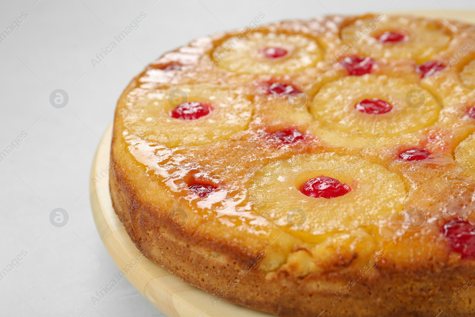 Photo of Tasty pineapple cake with cherries on white background, closeup. Space for text