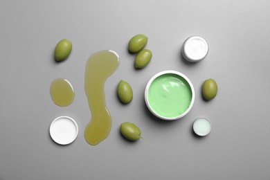 Flat lay composition with jars of body cream on grey background