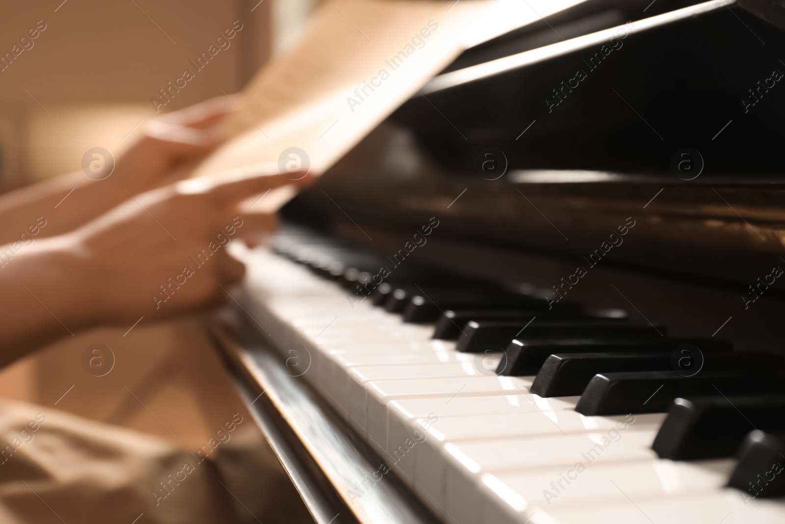 Photo of Modern piano with black and white keys, closeup. Space for text