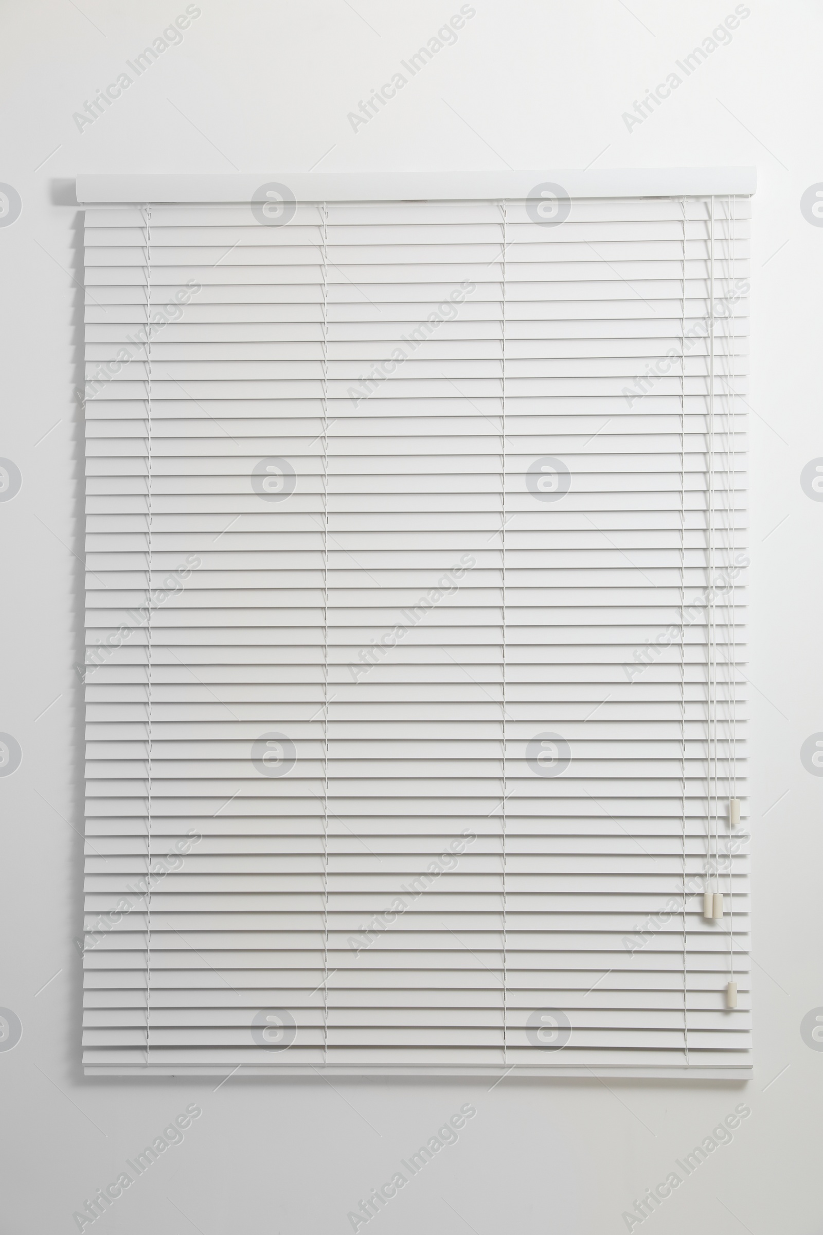 Photo of Modern window with closed blinds in room