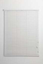 Photo of Modern window with closed blinds in room