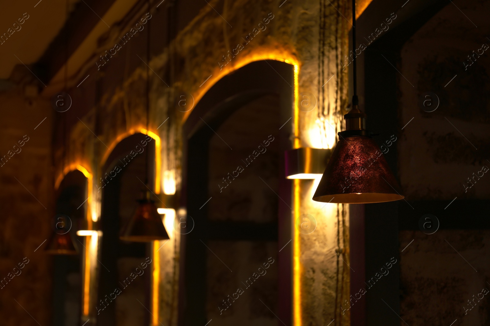 Photo of Different lamps with glowing light bulbs indoors