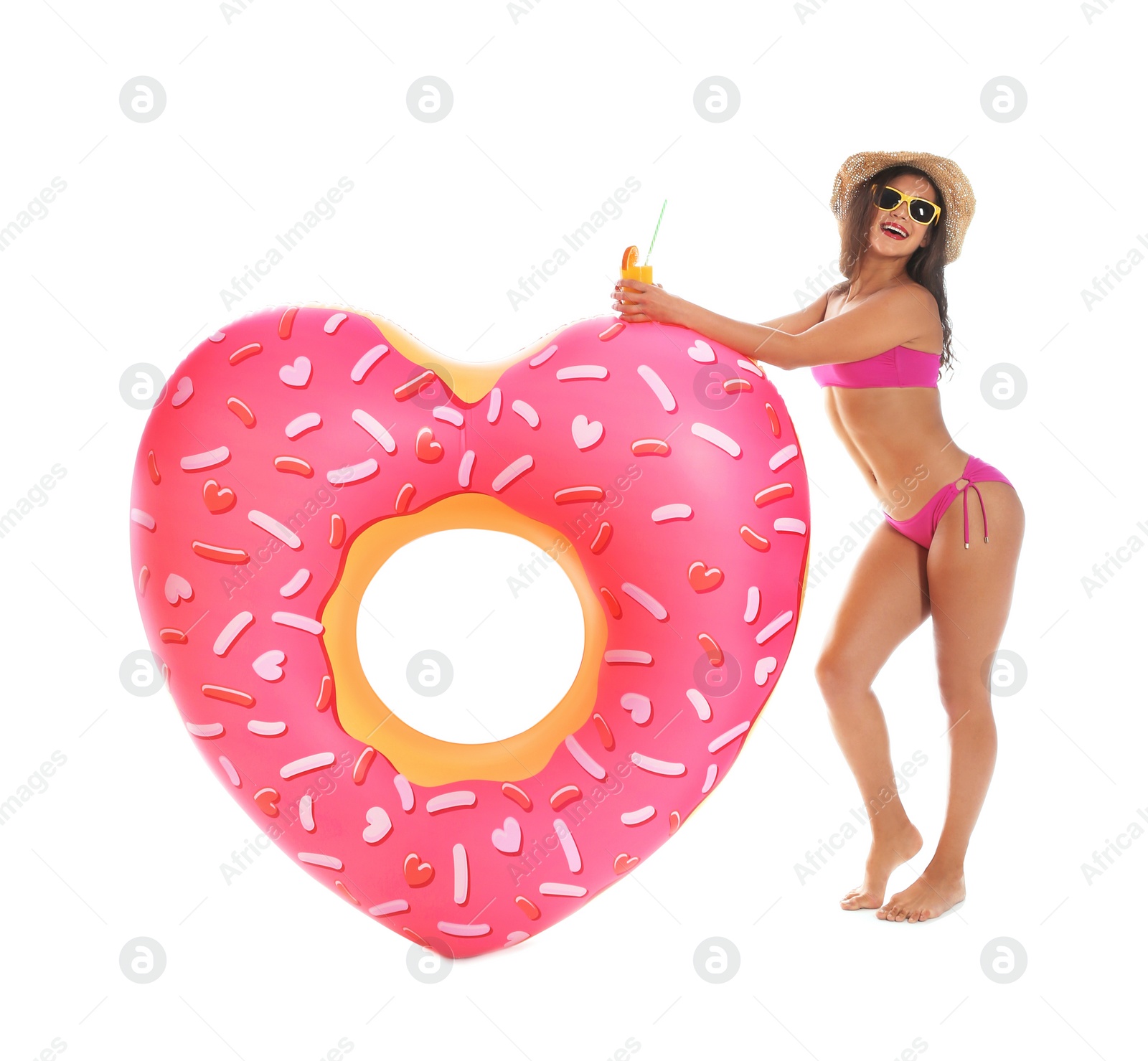 Photo of Beautiful young woman with inflatable heart and glass of cocktail on white background
