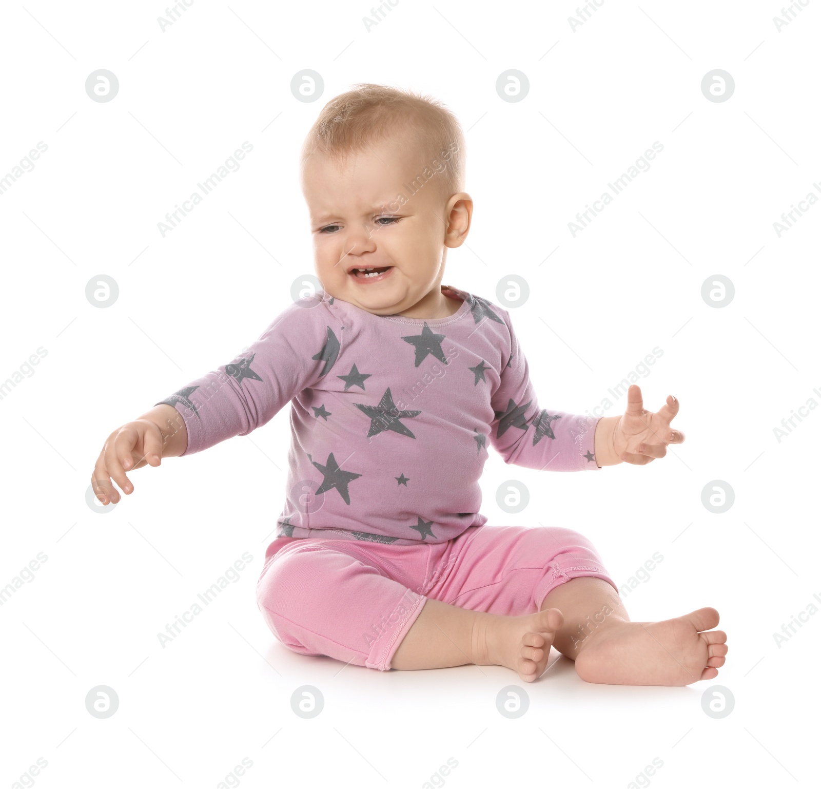 Photo of Upset baby girl sitting on white background