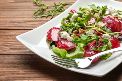 Plate with delicious beet salad served on table