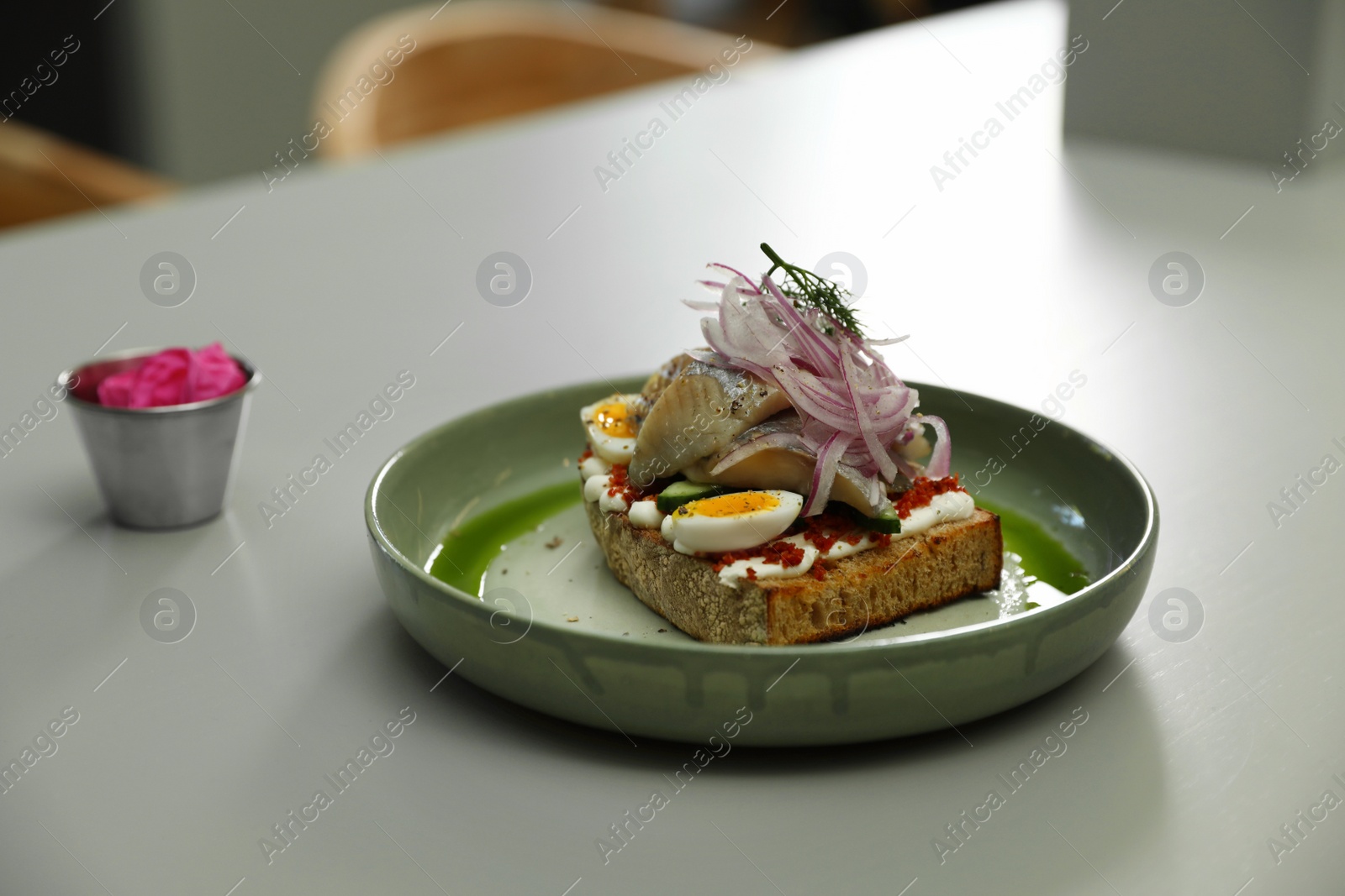 Photo of Tasty sandwich with fish on light table