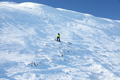 Photo of Male skier on slope at resort. Winter vacation