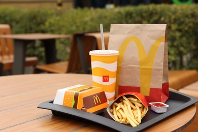 Lviv, Ukraine - October 9, 2023: McDonald's menu on wooden table outdoors, space for text