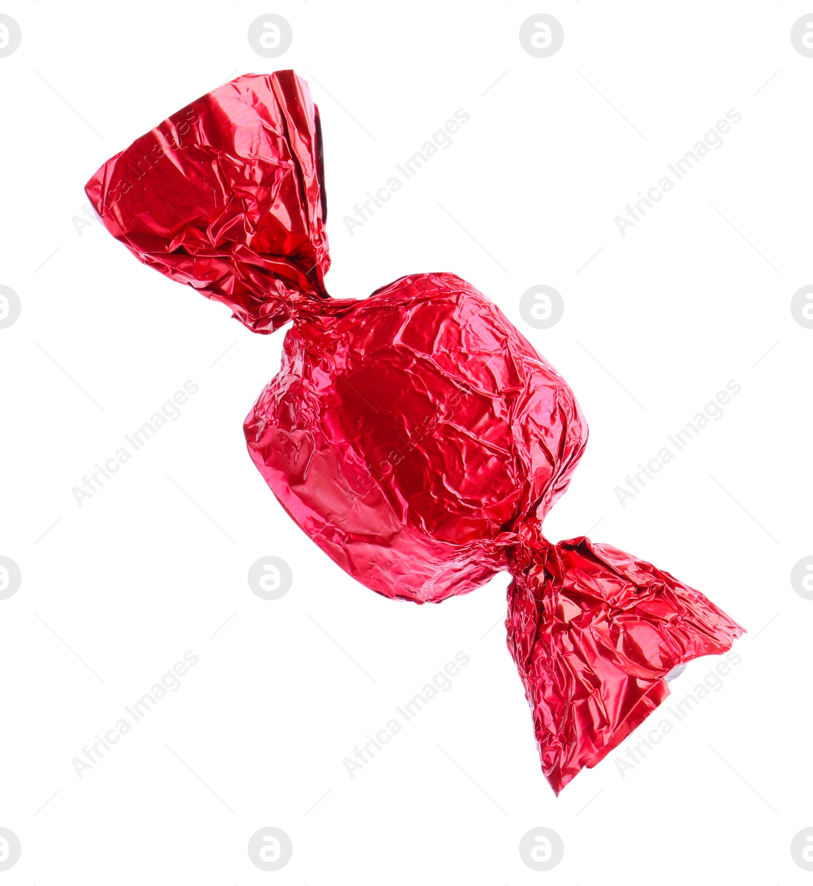 Photo of Tasty candy in red wrapper isolated on white