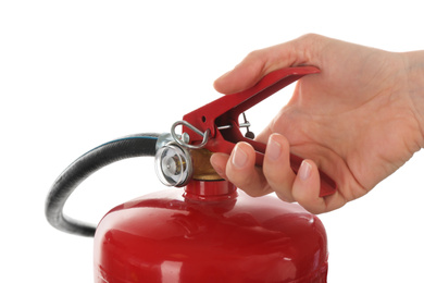 Woman using fire extinguisher on white background, closeup