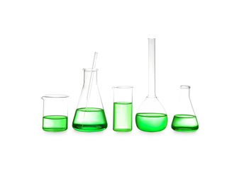 Different laboratory glassware with light green liquid isolated on white