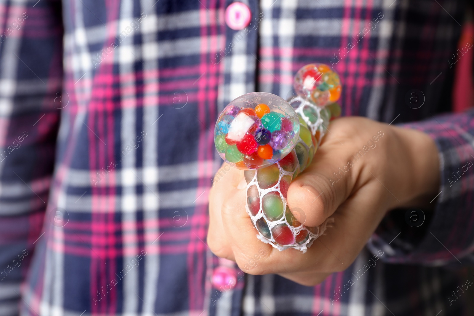 Photo of Woman squeezing colorful slime, closeup. Antistress toy