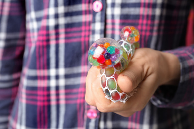 Woman squeezing colorful slime, closeup. Antistress toy