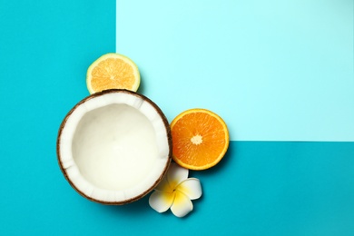 Photo of Flat lay composition with fresh coconut half on blue background. Space for text