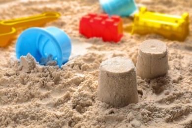 Little figures and beach toy set on sand. Outdoor play