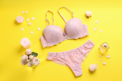 Photo of Flat lay composition with sexy women's underwear on yellow background