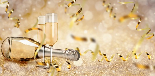 Image of Glasses and bottle of sparkling wine on bright festive background, banner design