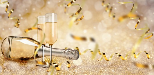 Glasses and bottle of sparkling wine on bright festive background, banner design