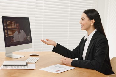 Photo of Human resources manager conducting online job interview via video chat on computer