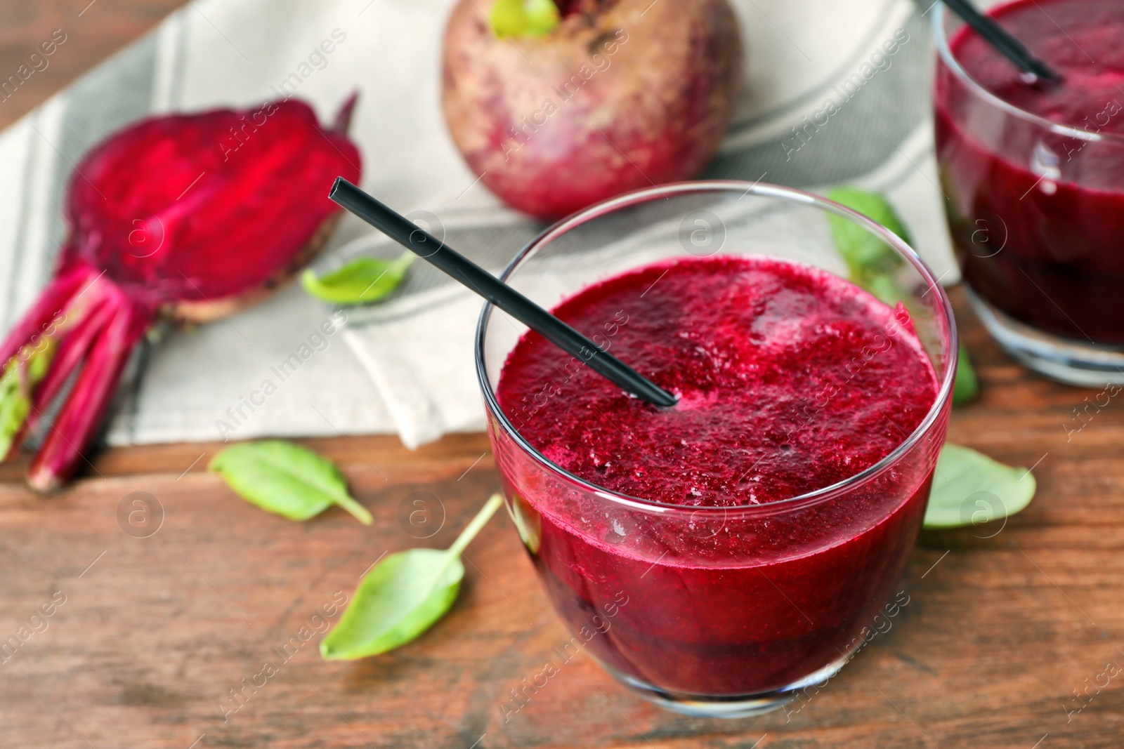 Photo of Glass of fresh beet juice on wooden table