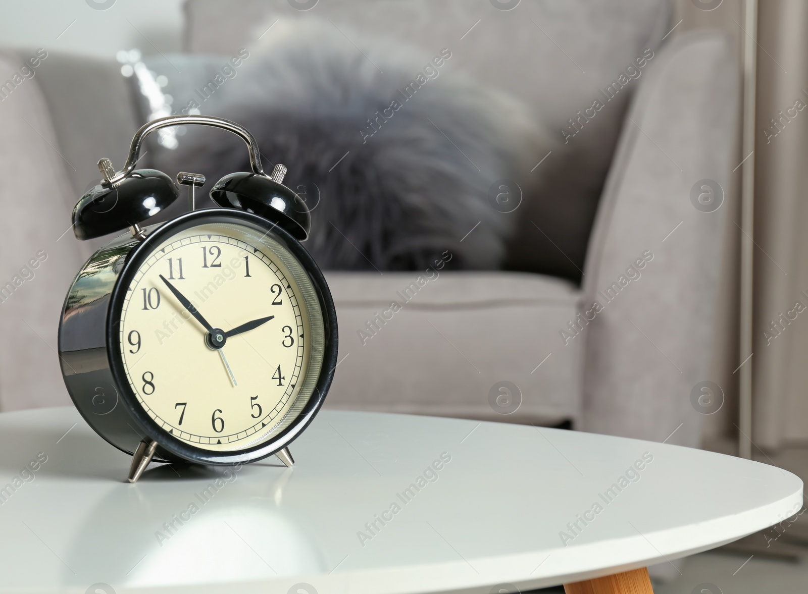 Photo of Alarm clock on table indoors, space for text. Time management