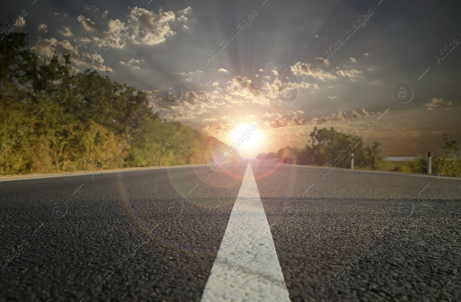 Image of Empty asphalt road at sunrise, closeup view