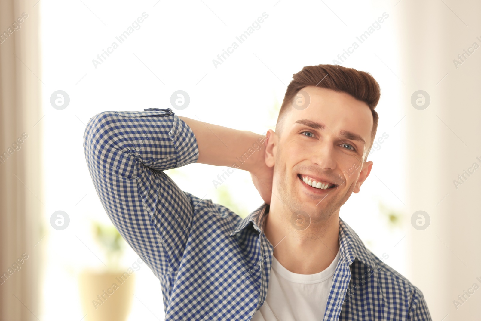 Photo of Portrait of young man with beautiful hair indoors