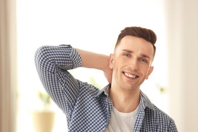 Portrait of young man with beautiful hair indoors