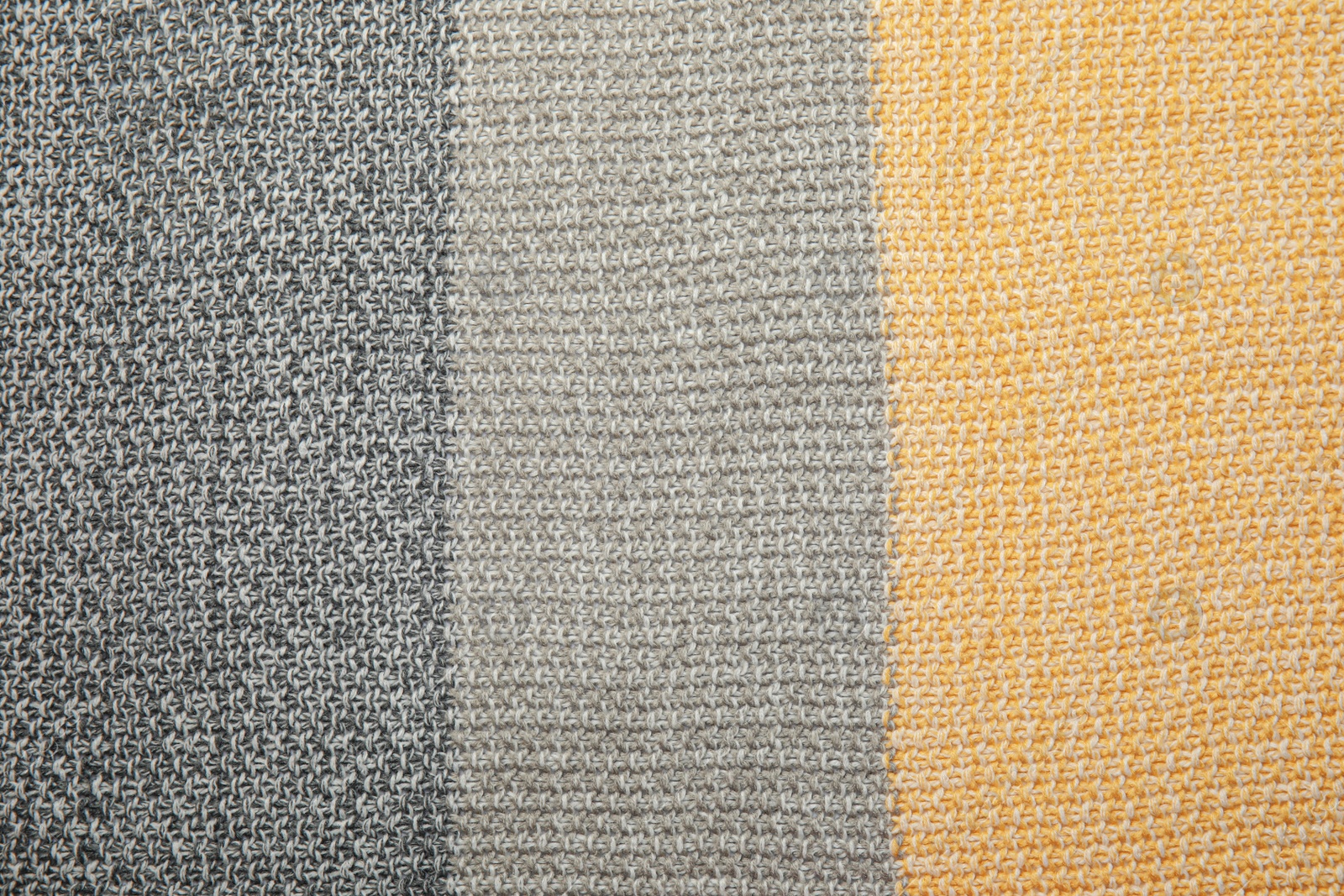 Photo of Soft striped knitted plaid as background, top view