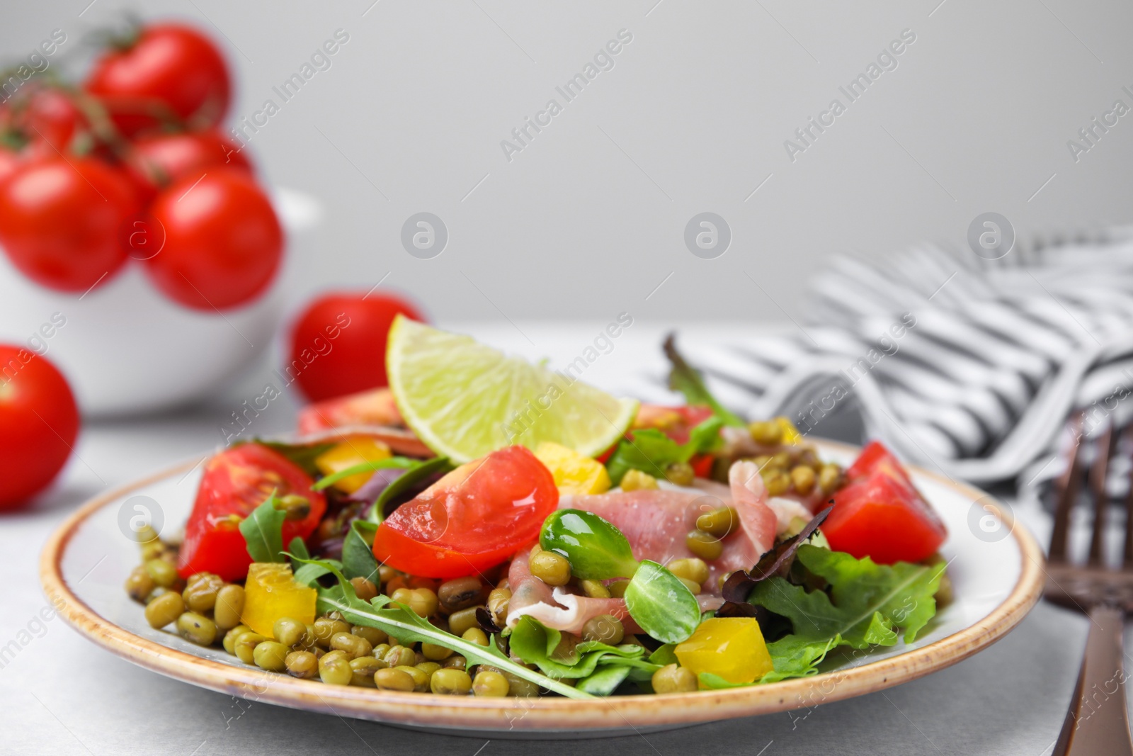 Photo of Plate of salad with mung beans on white table