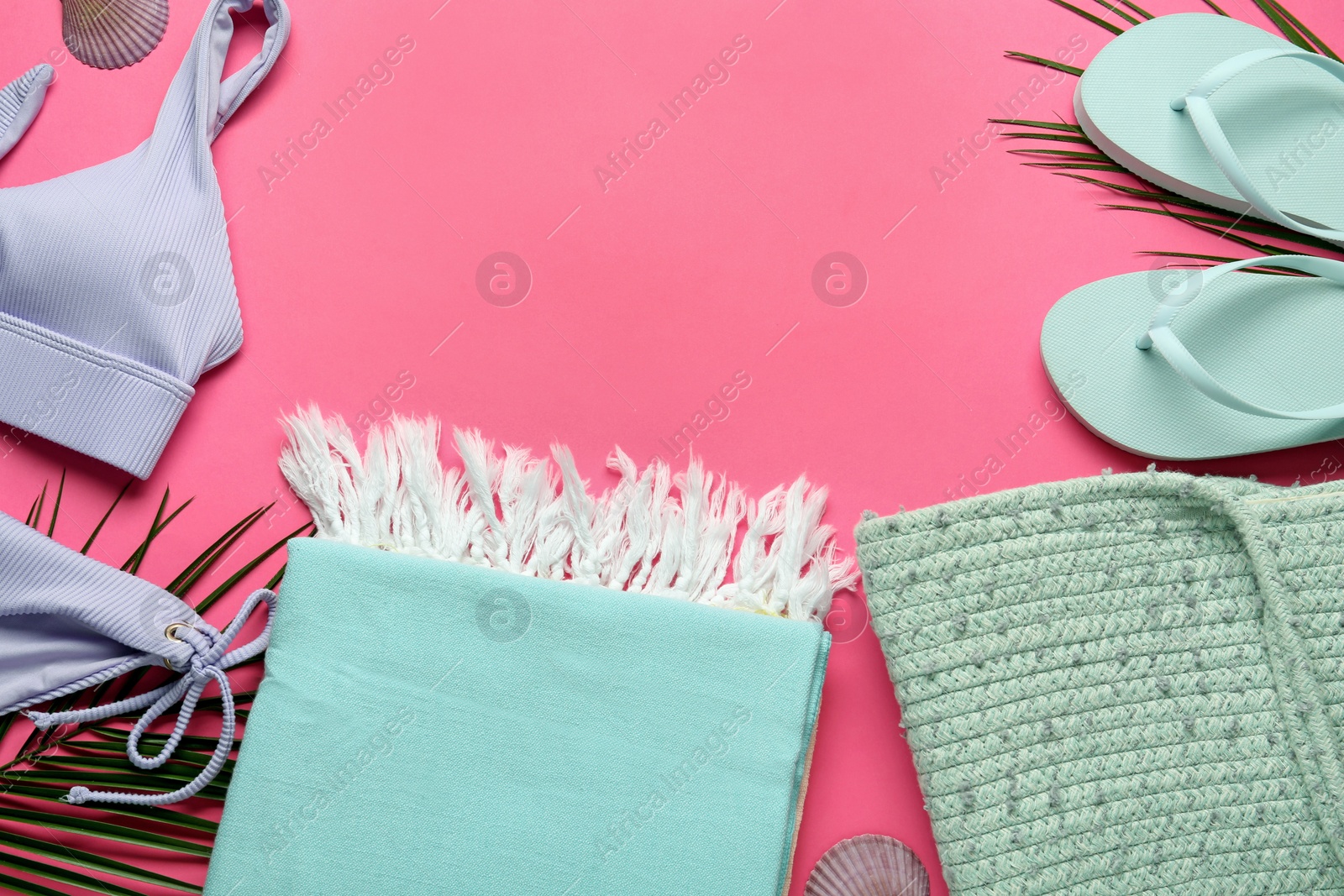 Photo of Flat lay composition with different beach objects on pink background, space for text