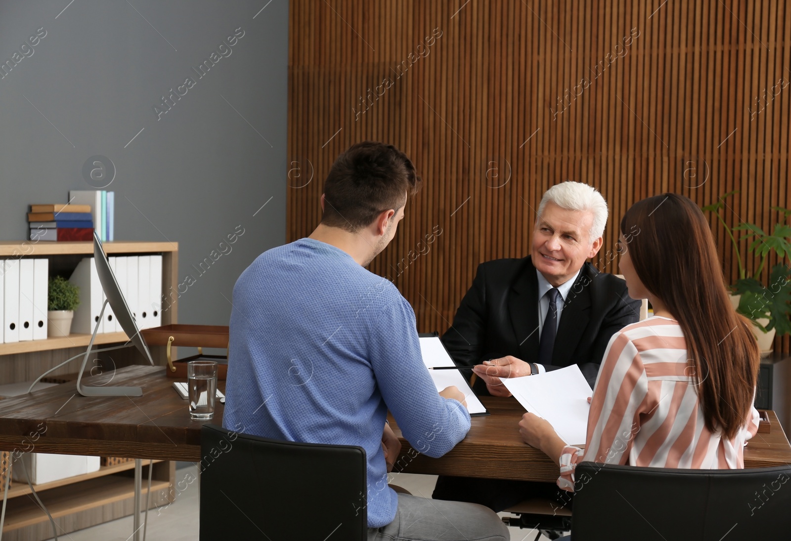 Photo of Lawyer having meeting with young couple in office