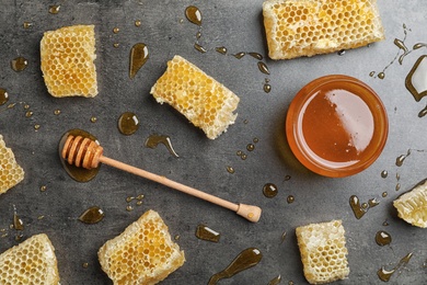 Photo of Flat lay composition with fresh honey on grey background