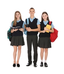 Full length portrait of teenagers in school uniform on white background