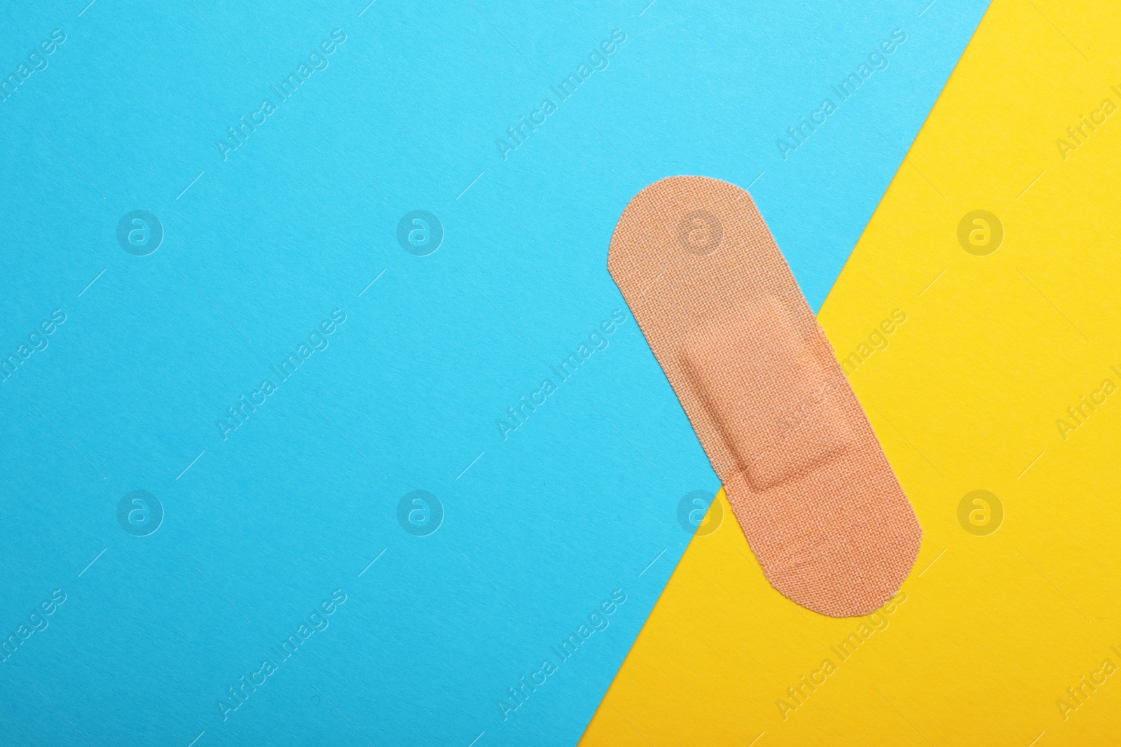 Photo of Sticking plaster on color background, top view. Space for text