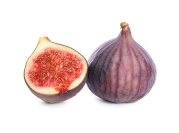 Photo of Whole and cut purple figs on white background